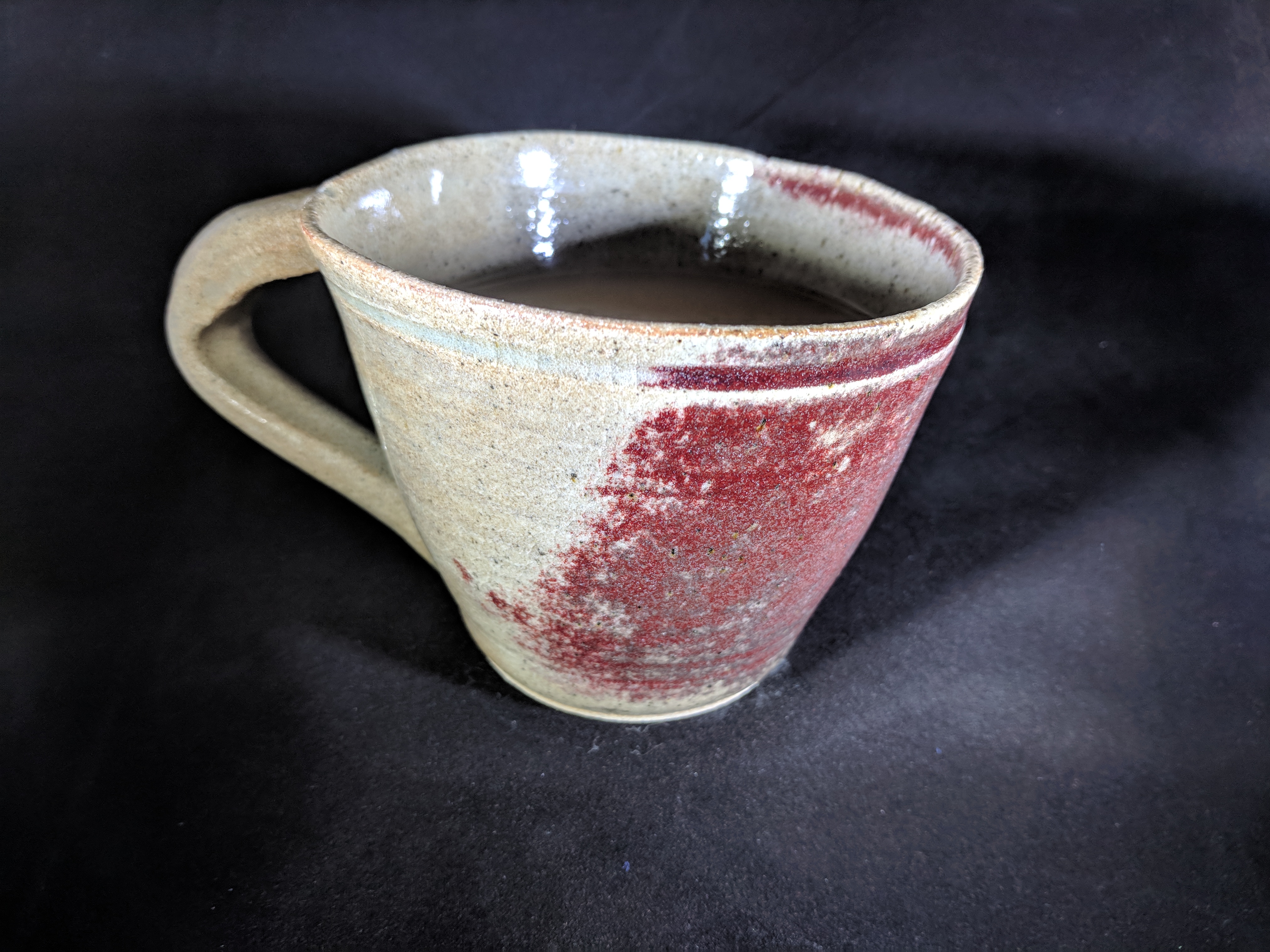 Brown and red mottled coffee cup