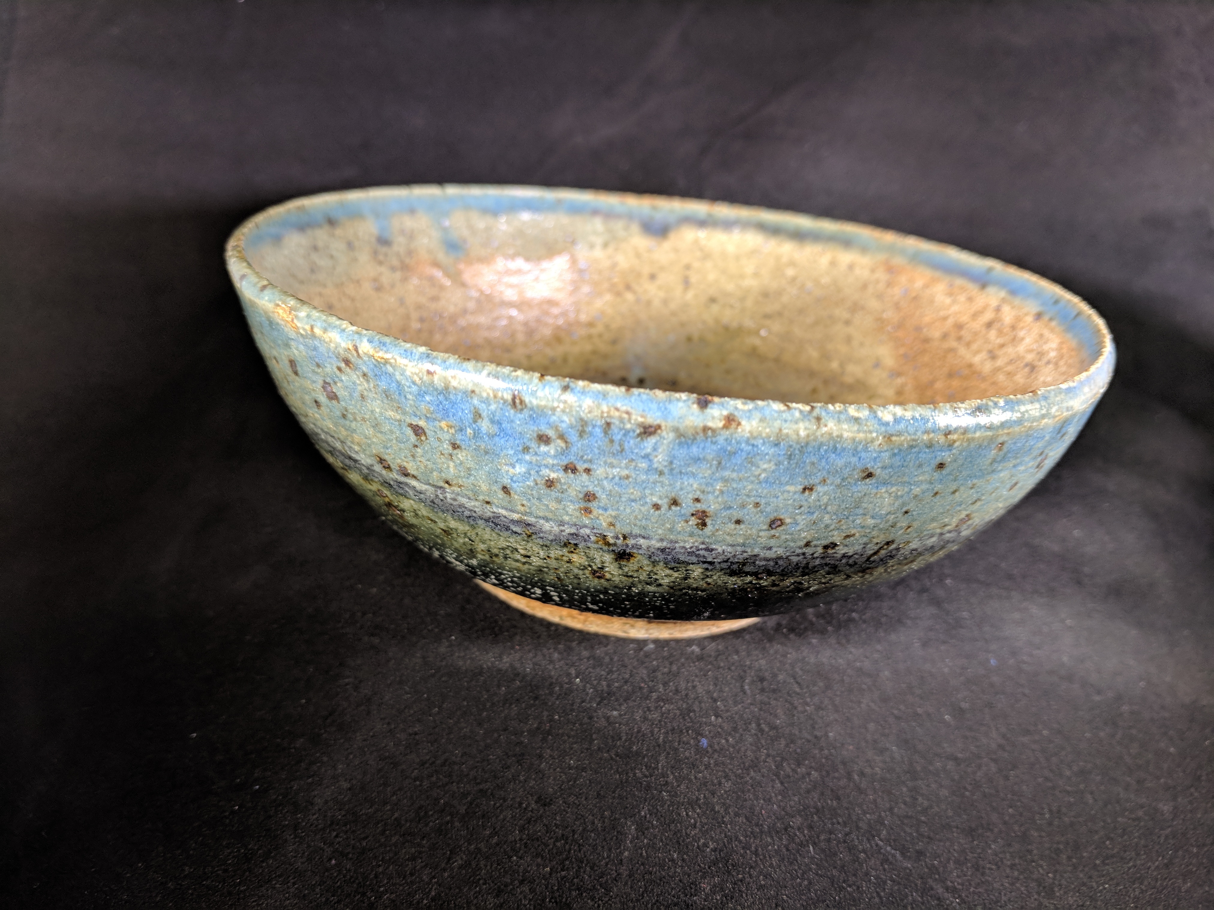 Multicolored bowl from purple to light blue, brown interior